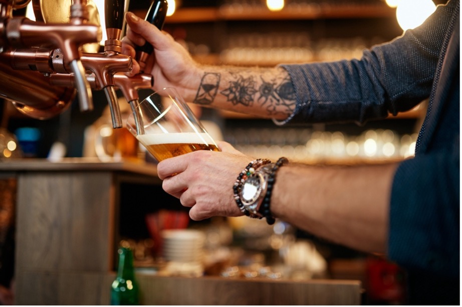 A person pouring beer from a tap