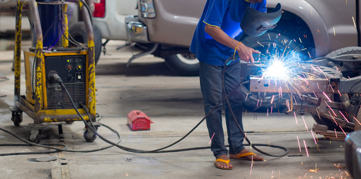 Metal welding steel works using electric arc welding machine to weld steel at factory. Metalwork manufacturing and construction maintenance service by manual skill labor concept.