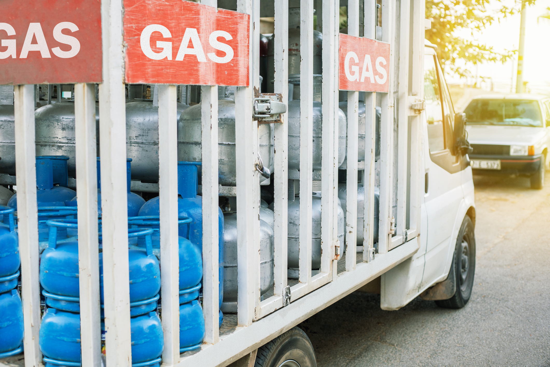 Truck with gas cylinders on the city road. Truck delivered propane cylinders.